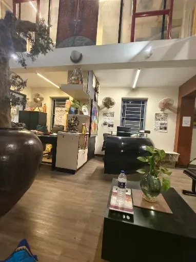 Double-Height Design Studio with Mezzanine & Artistic Display Modern Office Designs Desk and Decor 