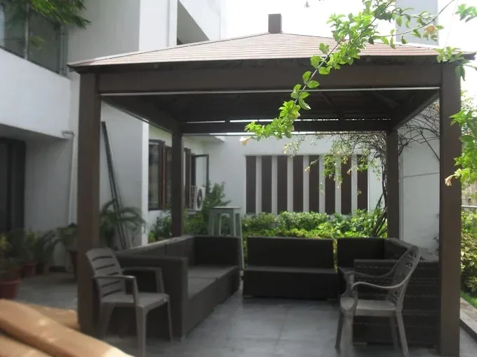 covered outdoor sit-out / semi-open patio corridor Courtyard Spaces Desk and Decor 