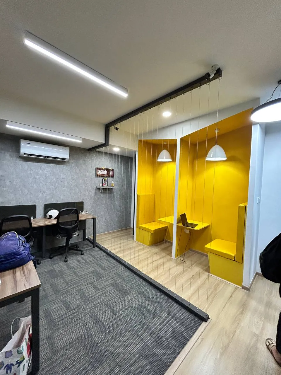 Vibrant Yellow Acoustic Collaboration Pods with Cable-Supported Open Partitioning Ergonomic Chairs Desk and Decor 