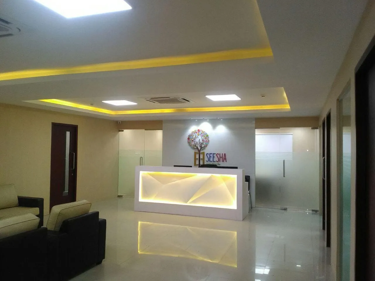 Backlit Geometric Feature Desk with Cove Lighting and Minimalist Interior Reception Desks Desk and Decor 