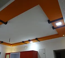 Geometric False Ceiling with Orange Beam Accents with Architectural False Ceiling & Lighting at Deskanddecor