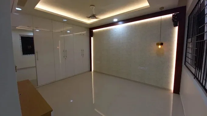 Bedroom with Glossy White Wardrobe & Backlit Feature Wall with Modern Living Room Designs at Deskanddecor