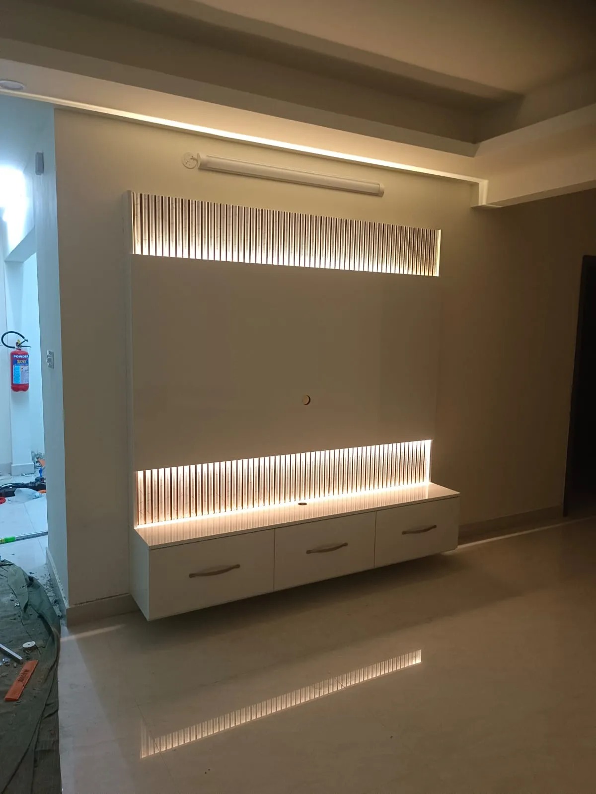 Modern Tri-Tone Master Wardrobe High-Gloss Finish with Integrated LED Vanity Station and Loft Storage with Floor Standing TV Units at Deskanddecor