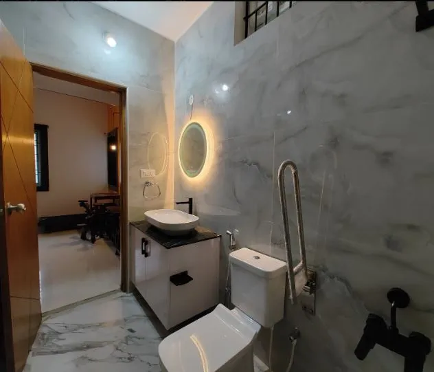 Bathroom with Marble Cladding & Backlit Circular Mirror with Modern Bathroom Designs at Deskanddecor